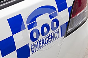 Emergency number 000 on a police car