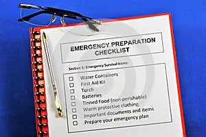 Emergency preparedness checklist.Emergency survival items.Water containers, first aid kit, torch, batteries, canned food, warm