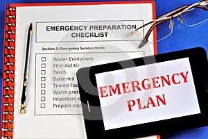 Emergency preparedness checklist.Emergency survival items.Water containers,first aid kit, torch, batteries, canned food, warm