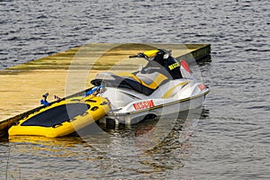 Emergency rescue jet ski moored to a wooden pier