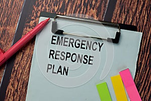 Emergency Response Plan write on a paperwork isolated on office desk photo