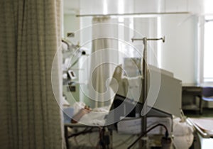 Emergency room with patient in bed, unfocused background