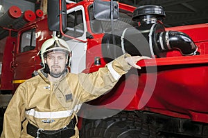 Emergency safety. Protection, rescue from danger. Fire fighter in protective helmet. Fire truck ready to respond to emergency,