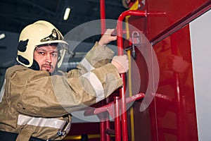 Emergency safety. Protection, rescue from danger. Fire fighter in protective helmet. Fire truck ready to respond to emergency,