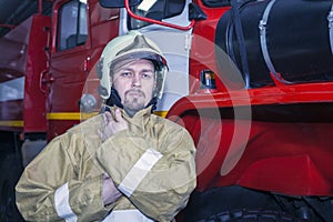Emergency safety. Protection, rescue from danger. Fire fighter in protective helmet. Fire truck ready to respond to emergency,