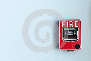 Emergency safety switch alarm red box install on white wall with pull down fire arrow direction for ringing the bell alarm on off