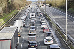 Emergency services closing motorway to attend accident causing a traffic jam