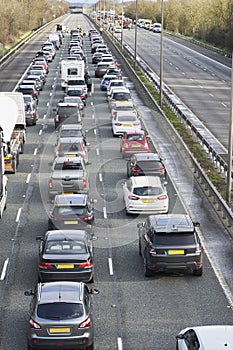 Emergency services closing motorway to attend accident causing a traffic jam