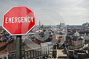 Emergency sign on Brussels city center background. Financial crash in world economy because of coronavirus. Global economic crisis