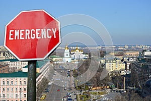 Emergency sign on Kyiv view background. Financial crash in world economy because of coronavirus. Global economic crisis