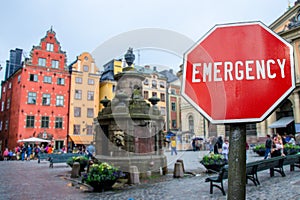 Emergency sign on Stockholm old town background. Financial crash in world economy because of coronavirus. Global economic crisis,