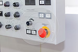 The emergency stop button on the control panel of the CNC