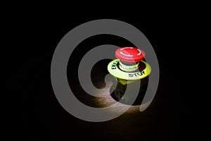 Emergency stop button, Disaster protection. Industrial concept. Red button on table in dark low key background