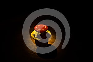 Emergency stop button, Disaster protection. Industrial concept. Red button on table in dark low key background