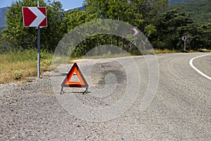 An emergency stop sign for a vehicle is installed on the road. Copy space