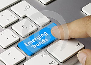 Emerging Trends - Inscription on Blue Keyboard Key