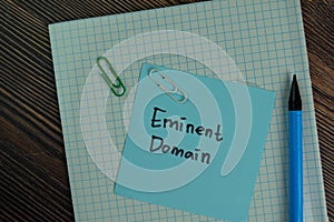 Eminent Domain write on sticky notes isolated on Wooden Table photo