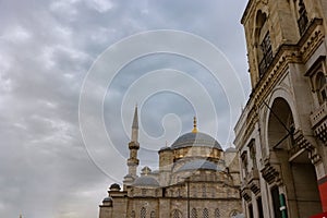 Eminonu New Mosque or Yeni Cami with cloudy sky. Travel to Istanbul