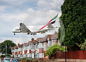 Emirates Airbus A380 plane landing over houses