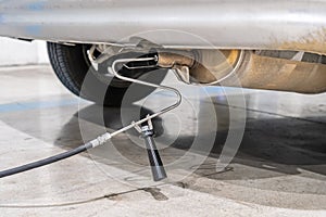 Emission control in the exhaust of an old car at a vehicle inspection station