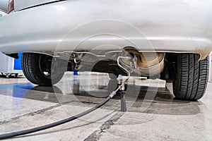 Emission control in the exhaust of an old car at a vehicle inspection station photo