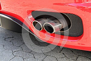 Emission pipe of a red car