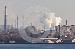 Emission of smoke from pipes of a metallurgical plant. The problem of air pollution and global warming. Environmental protection