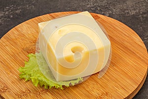 Emmental cheese over wooden board