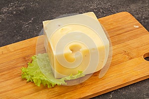 Emmental cheese over wooden board