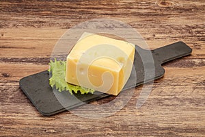 Emmental cheese over wooden board