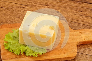 Emmental cheese over wooden board