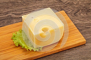 Emmental cheese over wooden board