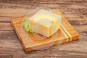 Emmental cheese over wooden board