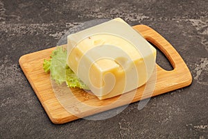 Emmental cheese over wooden board