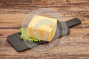 Emmental cheese over wooden board