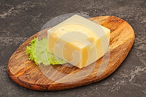 Emmental cheese over wooden board