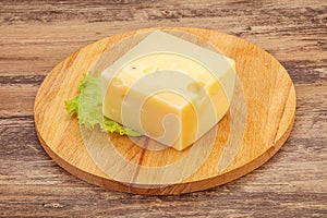 Emmental cheese over wooden board