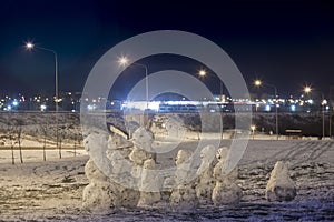 Emocional snowman`s family at december night