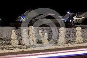 Emocional snowman`s family at december night photo