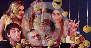 Emoji icons with friends taking a selfie in the background 4k