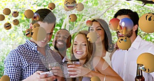 Emoji icons with friends taking a selfie in the background 4k