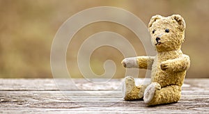 Emotion, feeling, hope concept, retro toy bear giving his paws