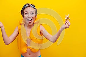 Emotion of happiness and joy in a boy. The joy of a tourist. Orange background for banner of traveler with a boy