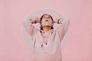 Emotional angry woman screaming on pink backdrop