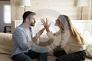 Emotional annoyed stressed couple arguing at home. photo