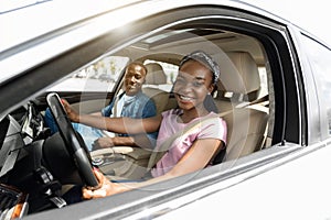 Emotional black family having car ride on weekend