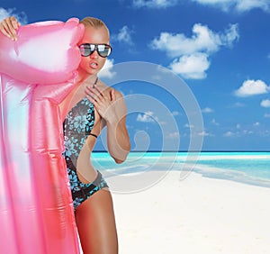 Emotional blond woman with water matress photo