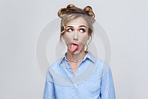 Emotional blonde girl have a crazy face and tongue out