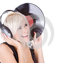 Emotional blonde in headphones with vinyl record