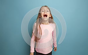 The emotional blonde teen girl have a happiness look and screaming. Studio shot